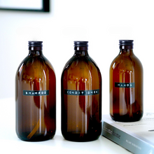 Load image into Gallery viewer, Amber Glass Or Plastic Bottle With Stamped Label & Black Metal Screw Lid