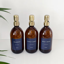 Load image into Gallery viewer, Set Of 3 Amber Bottles - Glass Or Plastic - Dark Blue Labels - Brushed Gold Metal Pumps
