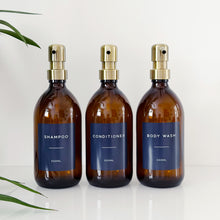 Load image into Gallery viewer, Set Of 3 Amber Bottles - Glass Or Plastic - Dark Blue Labels - Brushed Gold Metal Pumps