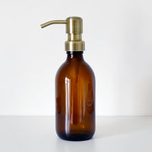 Load image into Gallery viewer, Amber Glass Or Plastic Dispenser Bottle With Light Brushed Gold Metal Pump