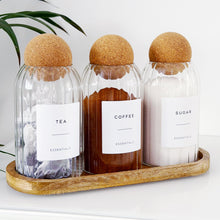 Load image into Gallery viewer, Three glass bottles labeled 'Tea', 'Coffee', and 'Sugar' with cork lids on a wooden tray.