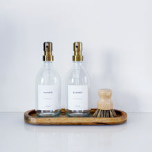 Load image into Gallery viewer, Set Of 2 Clear Bottles - Glass Or Plastic - Hands & Dishes - Brushed Light Gold Metal Pumps