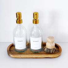 Load image into Gallery viewer, Set Of 2 Clear Bottles - Glass Or Plastic - Hands & Dishes - Gold Metal Pumps