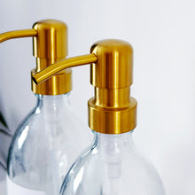 Load image into Gallery viewer, Set Of 2 Clear Bottles - Glass Or Plastic - Hands & Dishes - Gold Metal Pumps