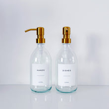 Load image into Gallery viewer, Set Of 2 Clear Bottles - Glass Or Plastic - Hands & Dishes - Gold Metal Pumps