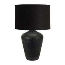Load image into Gallery viewer, Taika black ribbed wood table lamp base with a black linen fabric drum lamp shade. Ideal for a Mediterranean inspired home interior.