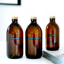 Load image into Gallery viewer, Amber Glass Or Plastic Bottle With Stamped Label &amp; Gold Metal Screw Lid
