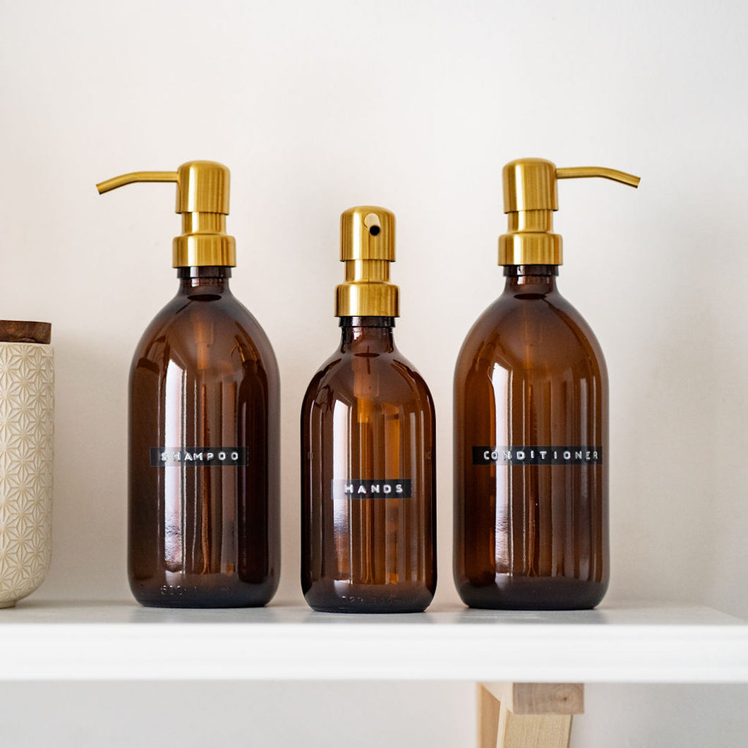 Amber Dispenser Bottle With Stamped Personalised Label And Gold Metal Pump