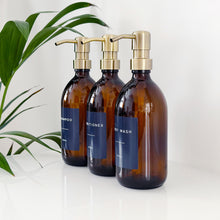 Load image into Gallery viewer, Set Of 3 Amber Bottles - Glass Or Plastic - Dark Blue Labels - Brushed Gold Metal Pumps
