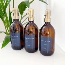 Load image into Gallery viewer, Set Of 3 Amber Bottles - Glass Or Plastic - Dark Blue Labels - Brushed Gold Metal Pumps
