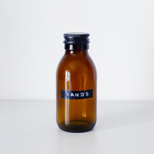 Load image into Gallery viewer, Amber Glass Or Plastic Bottle With Stamped Label &amp; Black Metal Screw Lid
