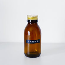 Load image into Gallery viewer, Amber Glass Or Plastic Bottle With Stamped Label &amp; Gold Metal Screw Lid
