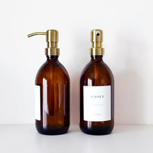 Load image into Gallery viewer, Set Of 2 Amber Bottles - Glass Or Plastic - Hands &amp; Dishes - Brushed Light Gold Metal Pumps
