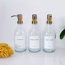 Load image into Gallery viewer, Set Of 3 Clear Bottles - Glass Or Plastic - Shampoo, Conditioner &amp; Body Wash - Brushed Light Gold Metal Pumps
