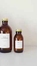 Load and play video in Gallery viewer, Amber Glass Or Plastic Bottle With White Label &amp; Gold Metal Screw Lid
