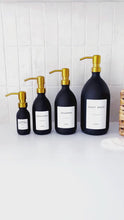 Load and play video in Gallery viewer, Matt Black Glass Dispenser Bottle With Personalised Label &amp; Gold Metal Pump
