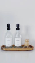 Load and play video in Gallery viewer, Set Of 2 Clear Bottles - Glass Or Plastic - Hands &amp; Dishes - Black Metal Pumps
