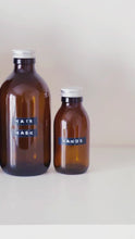 Load and play video in Gallery viewer, Amber Glass Or Plastic Bottle With Stamped Label &amp; Silver Metal Screw Lid
