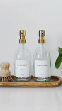 Load and play video in Gallery viewer, Set Of 2 Clear Bottles - Glass Or Plastic - Hand Soap &amp; Dish Soap - Brushed Light Gold Metal Pumps
