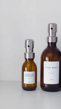 Load and play video in Gallery viewer, Amber Glass Or Plastic Dispenser Bottle With Personalised Label &amp; Silver Metal Pump
